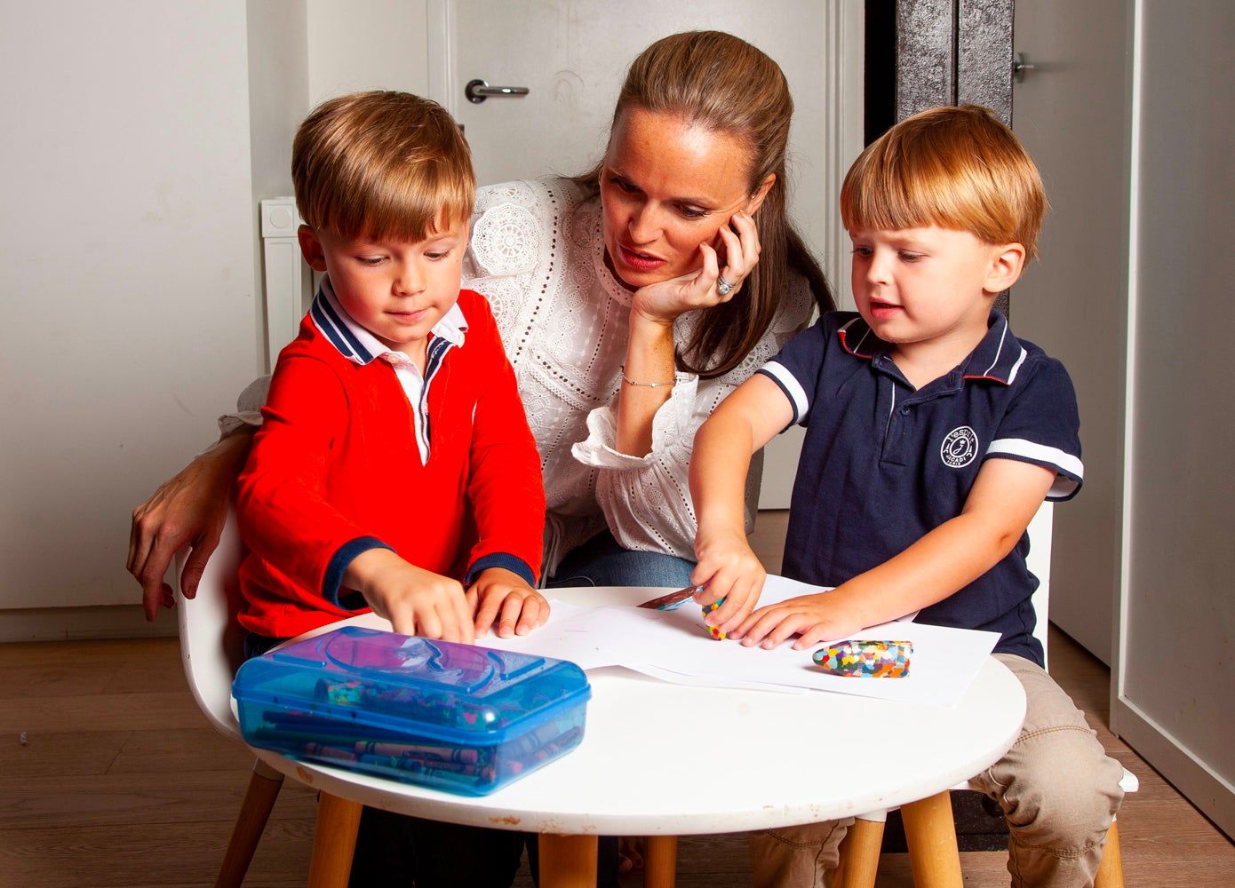 Sally King McBride and her two sons coloring at a small table