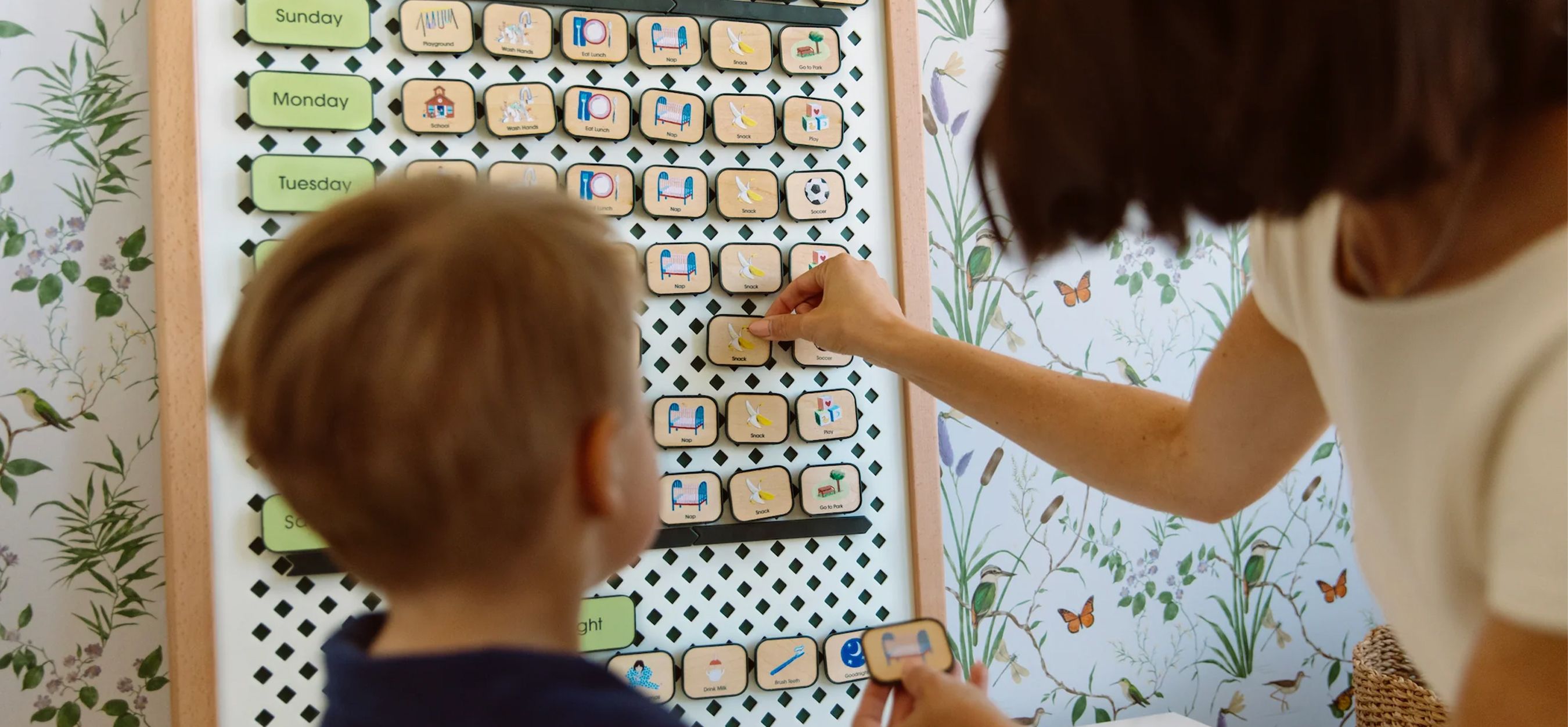 A mother and young child organize their summer calendar.