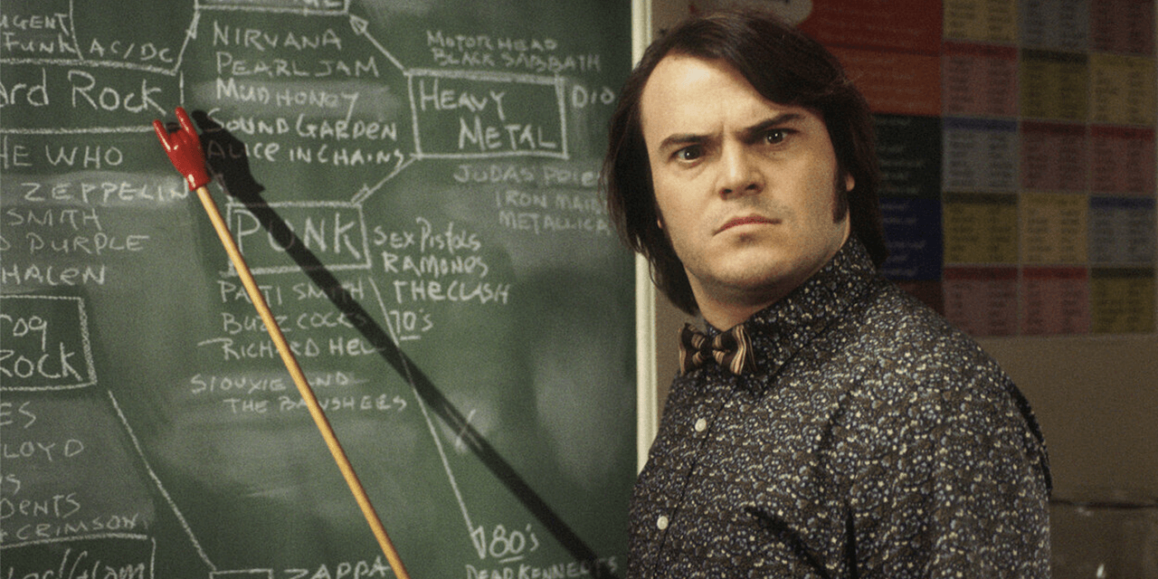 teacher from movie school or rock in front of a chalkboard
