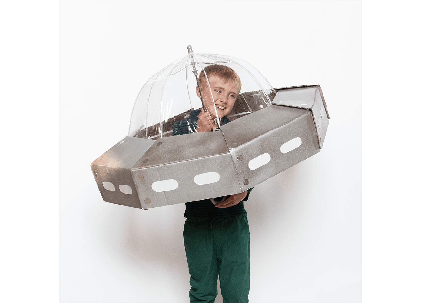 Boy dressed up as a UFO made of a clear umbrella and cardboard
