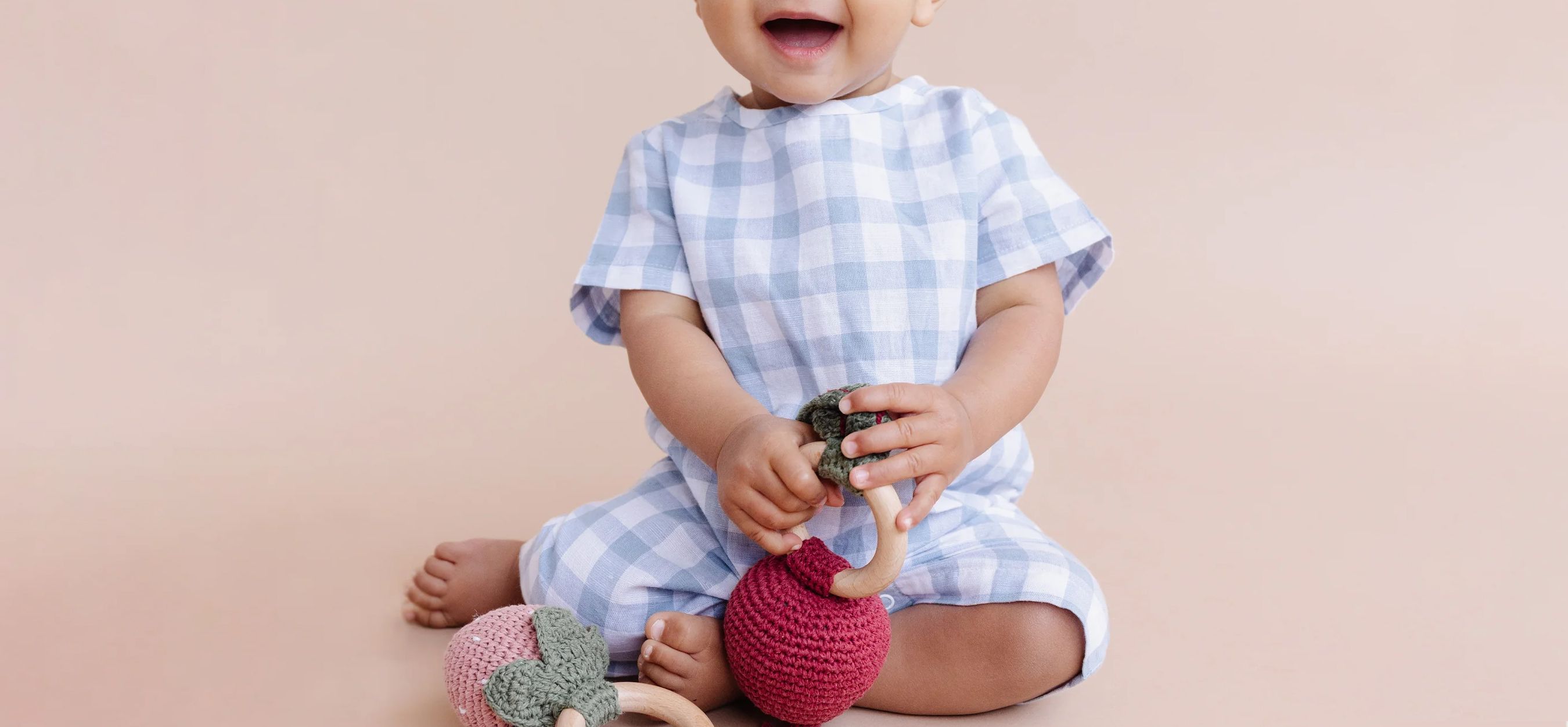 assortment of gifts for newborns like onesies and blankets