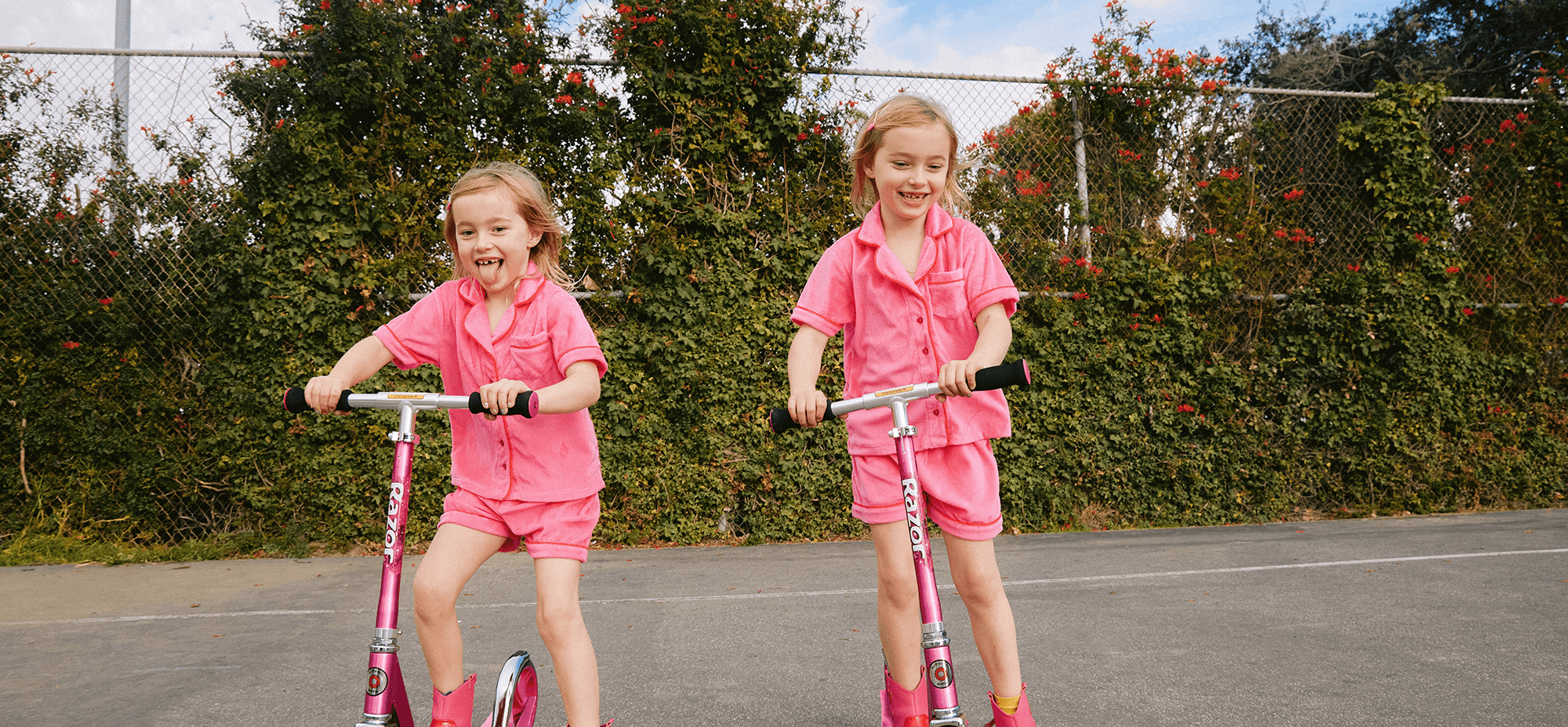 girls in pink on scooters 