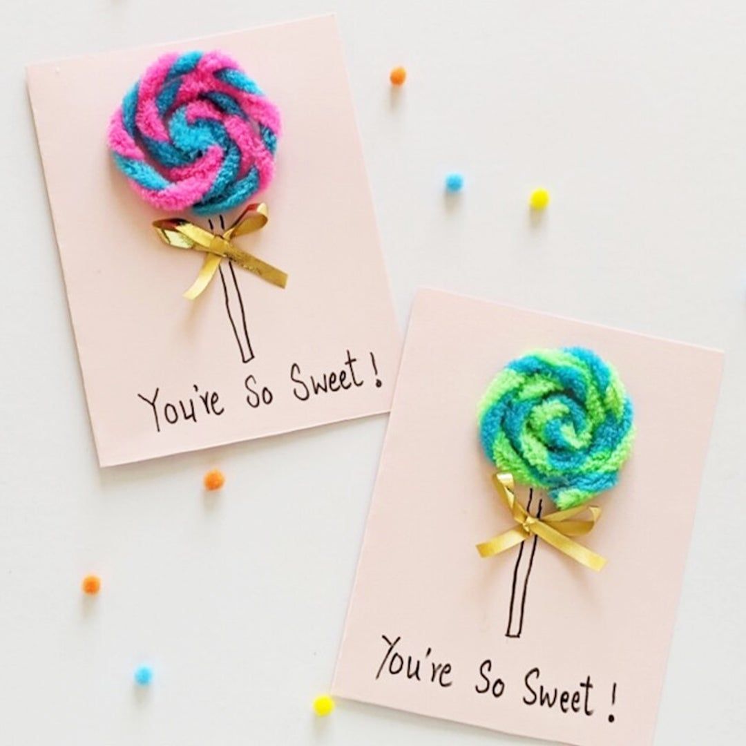 Two cards that read "You're So Sweet!" with pipe cleaner lollipops on top of them