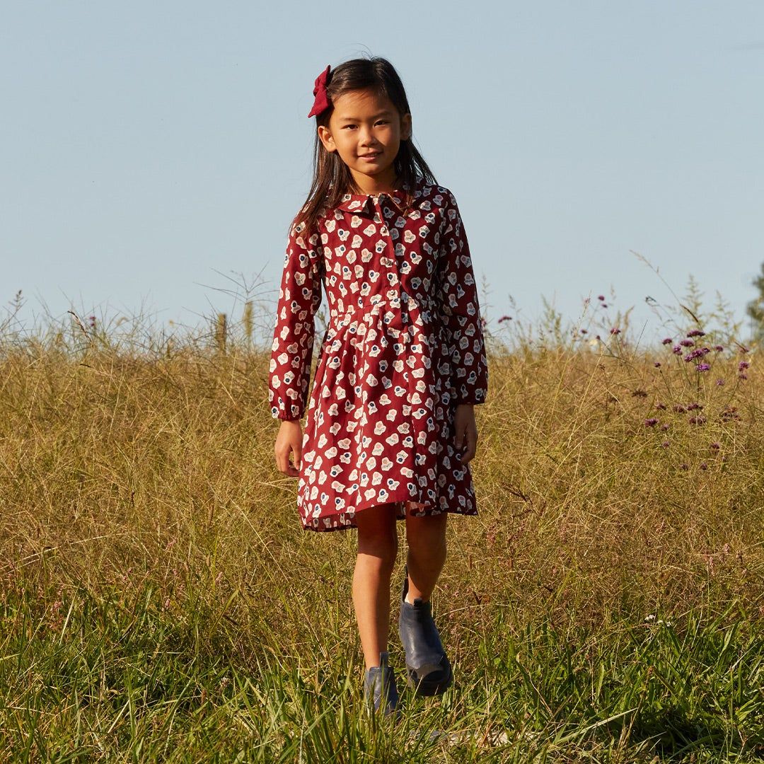 girl in Maison Me dress in a field 