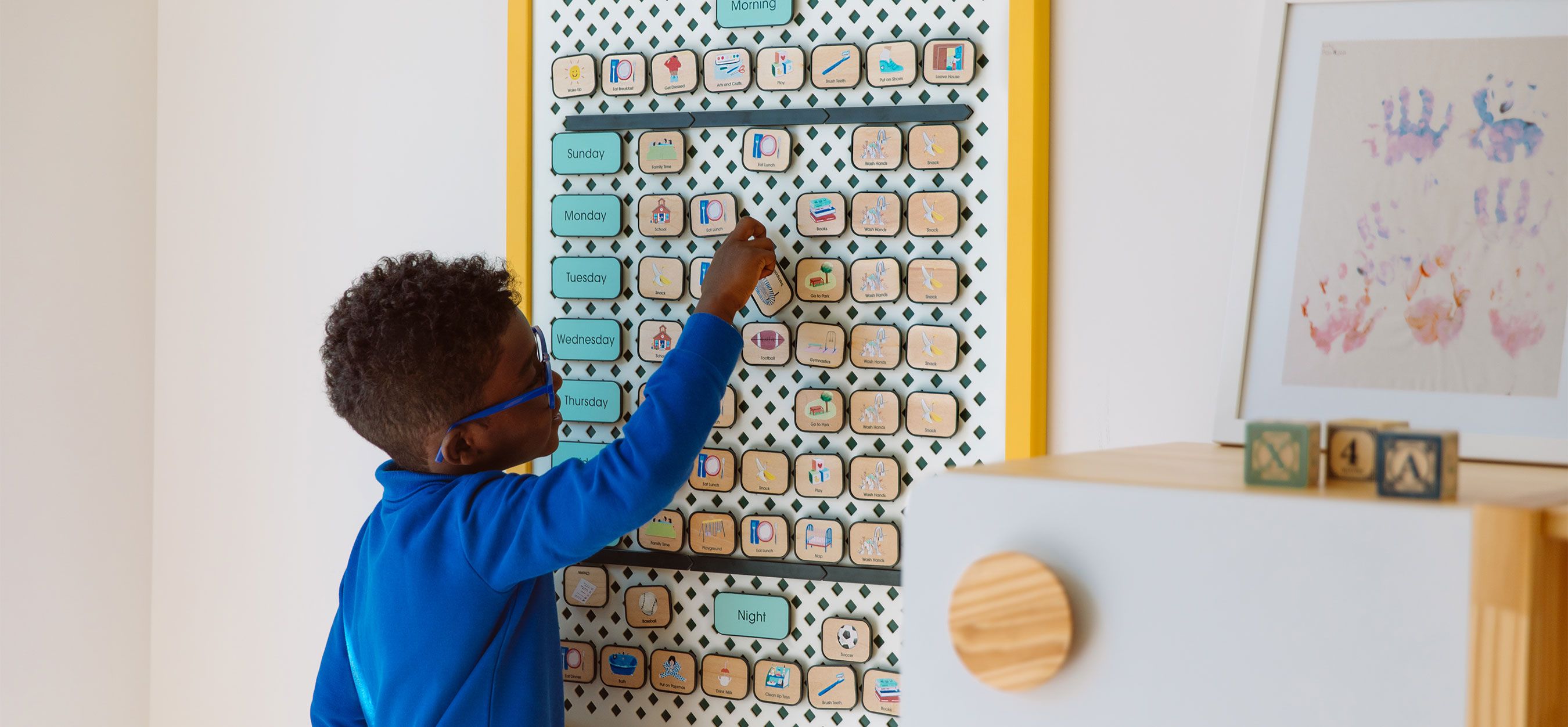 A young boy organizes his visual schedule.