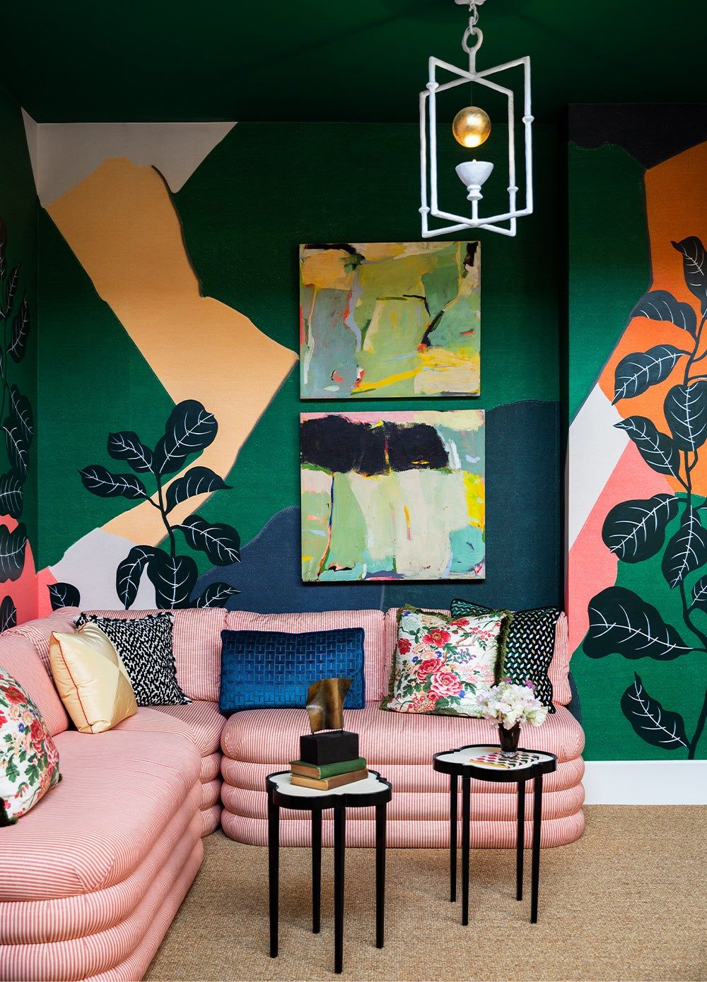tropical paintings over a pink couch