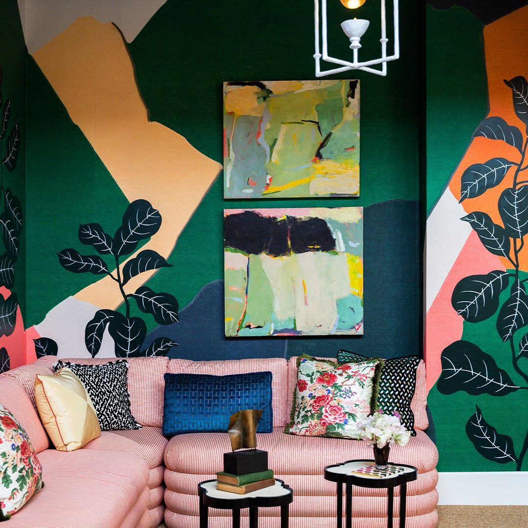 tropical paintings over a pink couch